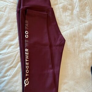 Peloton Maroon Leggings with White Text